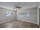 Spacious bedroom with vinyl flooring and ceiling fan at 7939 Riverdale Dr, New Port Richey, FL 34653