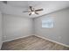 Bright bedroom with ceiling fan and wood-look flooring at 7939 Riverdale Dr, New Port Richey, FL 34653