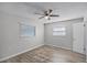 Spacious bedroom with ceiling fan and two windows at 7939 Riverdale Dr, New Port Richey, FL 34653