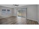 Dining room with hardwood floors, neutral walls, and sliding glass doors at 7939 Riverdale Dr, New Port Richey, FL 34653