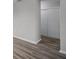 Hallway with light gray walls and wood-look floors, leading to bedrooms at 7939 Riverdale Dr, New Port Richey, FL 34653