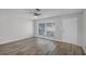 Living room with light gray walls, wood-look floors, and a ceiling fan at 7939 Riverdale Dr, New Port Richey, FL 34653