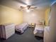 Bedroom with two twin beds, dresser, and ceiling fan at 38906 North Ave, Zephyrhills, FL 33542