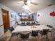 Bright dining area with tables and chairs near the kitchen at 38906 North Ave, Zephyrhills, FL 33542