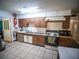 Kitchen with double sinks, stove, and microwave at 38906 North Ave, Zephyrhills, FL 33542