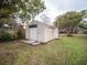 Detached storage shed with roll-up door and side door at 38906 North Ave, Zephyrhills, FL 33542