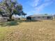 Large backyard with grassy area and mature tree at 3944 Nekoosa St, North Port, FL 34287