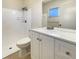 Updated bathroom with white vanity, shower, and tile flooring at 3944 Nekoosa St, North Port, FL 34287