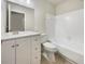 Clean bathroom with a white vanity, bathtub, and tiled flooring at 3944 Nekoosa St, North Port, FL 34287