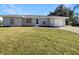 Newly renovated single-story home with a spacious lawn and attached garage at 3944 Nekoosa St, North Port, FL 34287