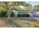 Ranch-style home with carport and mature landscaping at 4137 Glissade Dr, New Port Richey, FL 34652