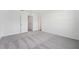 Bright bedroom with grey carpet and access to bathroom at 6188 Pina Colada St, Zephyrhills, FL 33542