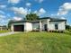 Modern house with dark brown garage door and paved driveway at 1379 Prairie Ter, North Port, FL 34286