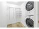 Laundry closet with stackable washer and dryer and shelving at 2333 Feather Sound Dr # A101, Clearwater, FL 33762