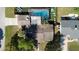 Aerial view of home features an enclosed pool, patio furniture, and a well-maintained roof at 1390 Eastfield Dr, Clearwater, FL 33764