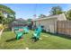 Backyard featuring a pool, outdoor seating and landscaped yard at 1390 Eastfield Dr, Clearwater, FL 33764