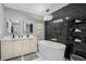 Luxurious bathroom featuring sleek black marble tile, a modern gold shower system, and a freestanding tub at 1390 Eastfield Dr, Clearwater, FL 33764