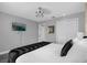 Bedroom features a queen bed, tv, and sliding closet doors at 1390 Eastfield Dr, Clearwater, FL 33764