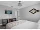 Bedroom featuring a queen bed, tv, and an arched mirror on the wall at 1390 Eastfield Dr, Clearwater, FL 33764