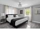 Bedroom featuring a queen-sized bed with neutral-colored walls and gray wood-look flooring at 1390 Eastfield Dr, Clearwater, FL 33764