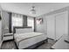 Bedroom featuring a king-sized bed, modern lighting fixture and sleek, minimalist design at 1390 Eastfield Dr, Clearwater, FL 33764