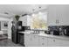 Updated kitchen featuring modern appliances, white cabinets, and quartz countertops at 1390 Eastfield Dr, Clearwater, FL 33764
