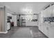 Modern kitchen with stainless appliances, white cabinetry, and a blue tile backsplash at 1390 Eastfield Dr, Clearwater, FL 33764