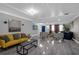Bright, open living area with grey plank flooring and stylish furniture and decor at 1390 Eastfield Dr, Clearwater, FL 33764