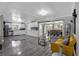 Open-concept living space features updated kitchen, dining area, living room and modern gray flooring at 1390 Eastfield Dr, Clearwater, FL 33764