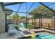 Screened pool area featuring a pool, outdoor seating and manicured landscaping at 1390 Eastfield Dr, Clearwater, FL 33764