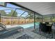Screened pool area with a pool, outdoor seating and manicured landscaping at 1390 Eastfield Dr, Clearwater, FL 33764