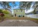 Large backyard with patio and neighboring houses visible at 7707 N Riverdale Ave, Tampa, FL 33604