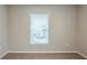 Simple bedroom with neutral walls, carpet, and a window at 7707 N Riverdale Ave, Tampa, FL 33604