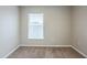 Bright bedroom with carpet flooring and a window with blinds at 7707 N Riverdale Ave, Tampa, FL 33604