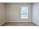 Spacious bedroom featuring carpet, window with blinds, and a closet at 7707 N Riverdale Ave, Tampa, FL 33604