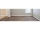 Empty bedroom with neutral walls, carpet, and a window at 7707 N Riverdale Ave, Tampa, FL 33604
