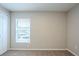 Simple bedroom with neutral walls, carpet, and a window at 7707 N Riverdale Ave, Tampa, FL 33604