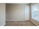 Spacious bedroom with neutral walls, carpet flooring and a window at 7707 N Riverdale Ave, Tampa, FL 33604