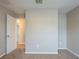 Simple bedroom with neutral walls, carpet, and a door at 7707 N Riverdale Ave, Tampa, FL 33604