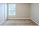 Simple bedroom with carpet, window with blinds, and closet at 7707 N Riverdale Ave, Tampa, FL 33604