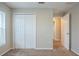 Bedroom with neutral walls, carpet flooring, and a door at 7707 N Riverdale Ave, Tampa, FL 33604