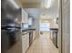 Open kitchen with white cabinets and black appliances at 7707 N Riverdale Ave, Tampa, FL 33604