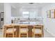 Renovated kitchen boasts marble island, wooden barstools, and contemporary finishes at 5116 11Th W Ave, Bradenton, FL 34209