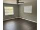 Spacious bedroom with large windows and dark hardwood floors at 8950 Baywood Park Dr, Seminole, FL 33777