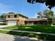 Beautiful two-story home with stone accents and a spacious lawn at 8950 Baywood Park Dr, Seminole, FL 33777