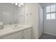 Clean bathroom with white vanity, shower, and gray tile floor at 11223 Spring Gate Trl, Bradenton, FL 34211