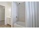 Bathroom with a shower/tub combo and gray tile at 11223 Spring Gate Trl, Bradenton, FL 34211