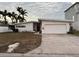 Mid-century modern home with attached garage and landscaped lawn at 11240 6Th E St, Treasure Island, FL 33706