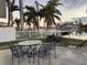 Waterfront patio with table and chairs, offering peaceful sunset views at 11240 6Th E St, Treasure Island, FL 33706