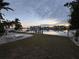 Scenic waterfront view with lush landscaping and private dock at 11240 6Th E St, Treasure Island, FL 33706